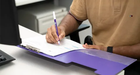 Person filling out a checklist